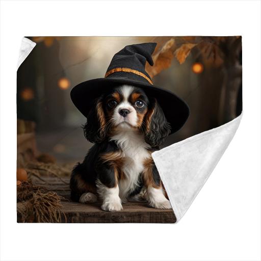 Cavalier pup learning magic in a Witches hat.